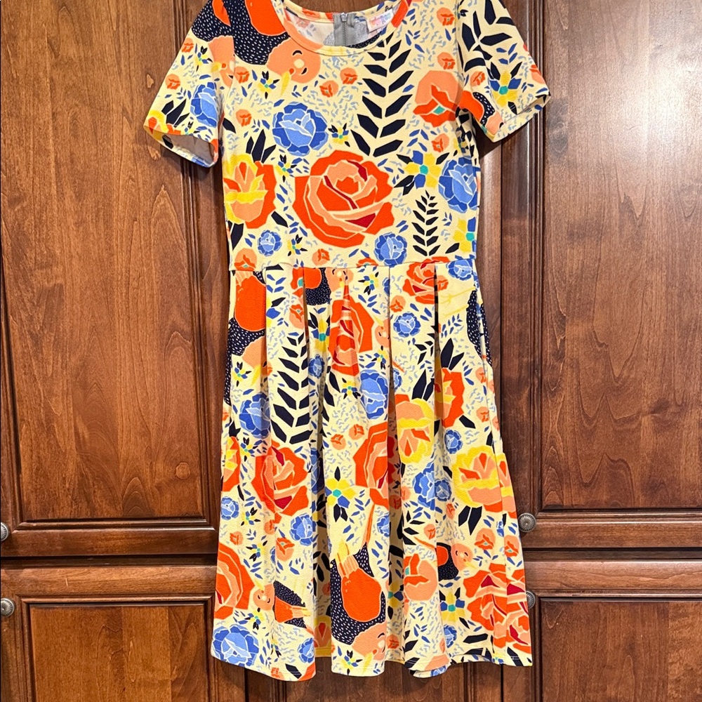 LuLaRoe Amelia Floral Dress in Orange, Blue, and Yellow background.